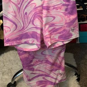 Two Justice gymnastic leotards with matching shorts.